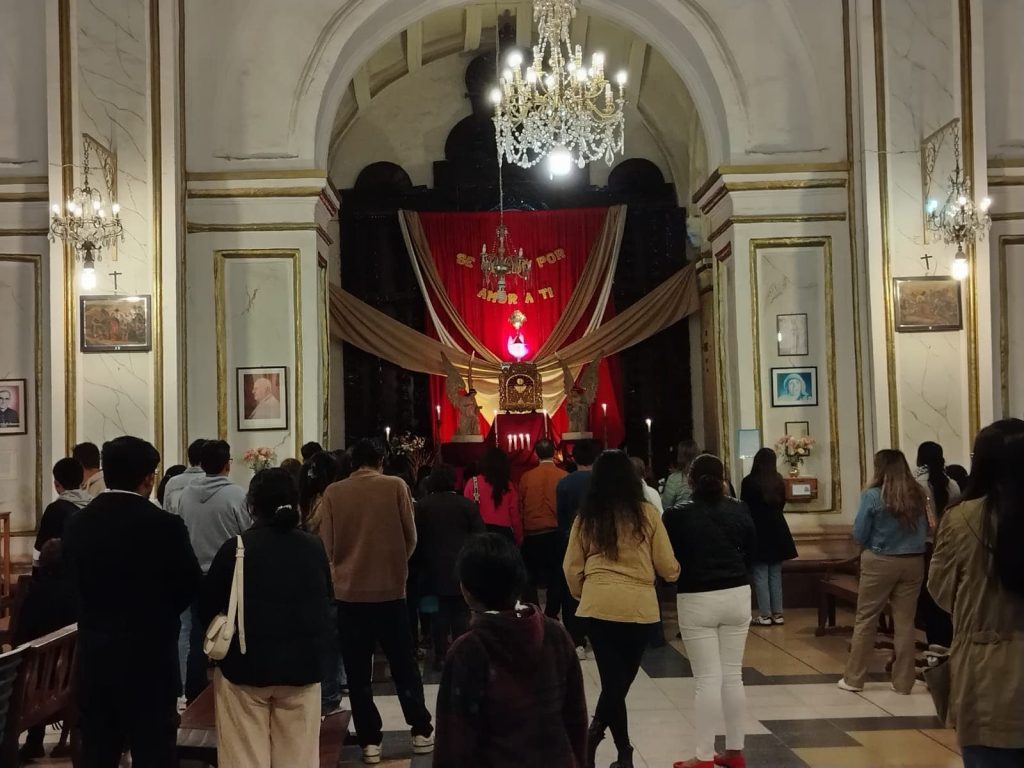 Travelers experiencing Semana Santa traditions inside a church in Sucre Bolivia