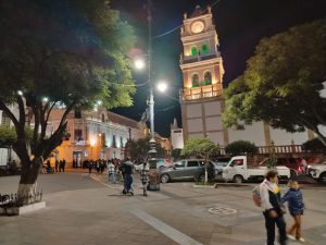 Sucre main square at night during Holy Week with illuminated church and local atmosphere