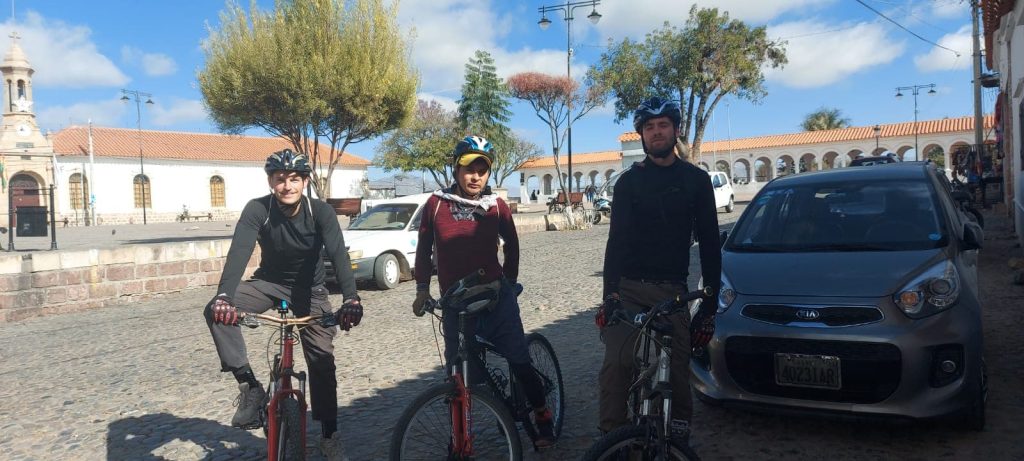 Cyclists riding along a rural road during the mountain bike tour from Sucre to Yotala